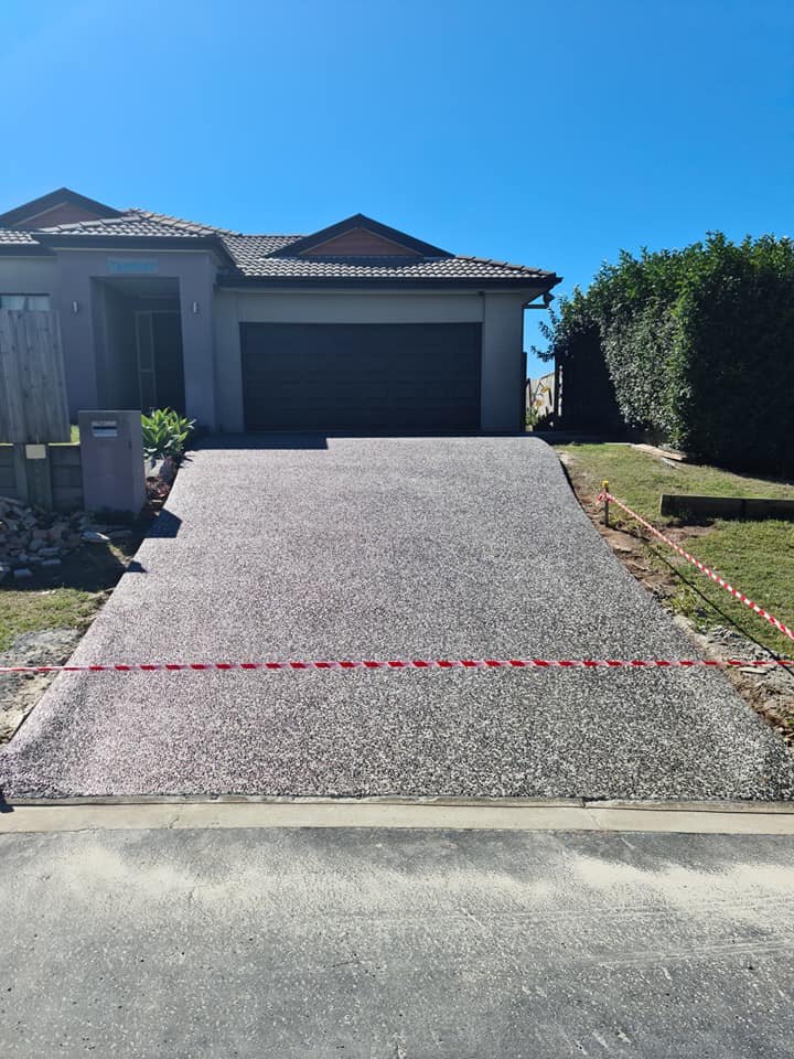 "Stunning and durable exposed aggregate driveway by our skilled concrete contractors. Enhance your home's curb appeal with our expert concrete services. Contact us for a free quote today!"